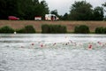 Degensbachsee, Germany, July 2019: Triathlon Ilshofen. Swimmers in lake and rescue car with supervising paramedic