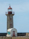 degrading red coast lighthouse with small vaulted roof house Royalty Free Stock Photo