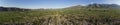 180 degree aerial panorama of village, farms, and mountains in Kyrgyzstan