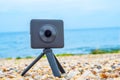360 degree camera on sea shore stone.