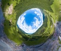 360 degree panoramic image of an abstract world turned inside out with green meadows around an oval sky with clouds in the Altai Royalty Free Stock Photo