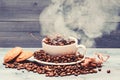 Degree of roasting grain. Cup full coffee brown roasted beans white clouds of smoke blue wooden background. Cafe drinks Royalty Free Stock Photo