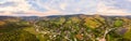 180 degrees panoramic landscape of countryside, aerial drone view of urban village Pidbuzh in Carpathians, Ukraine. Sunset time, Royalty Free Stock Photo