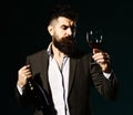 Degustator with beard and expensive alcohol on emerald background Royalty Free Stock Photo