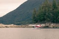 Dehavilland Beaver float plane going through a cut in an an island before take-off Royalty Free Stock Photo