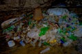 DEHRADUN, INDIA - NOVEMBER 07, 2015: Close up of garbage with plastic bottles, baskets, sacks in Tapkeshwar Mahadev