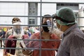 Health worker checking temperature of a migrant