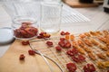 Dehydrate dried yellow and red tomatoes on stainless steel dehydrator tray and in glass jar for long term pantry in domestic