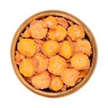 Dehydrated carrot slices in a wooden bowl, close up, from above