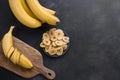 Dehydrated, dried banana chips on black background. View from above Royalty Free Stock Photo