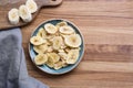 Dehydrated, dried banana chips on wooden board. View from above Royalty Free Stock Photo