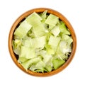 Dehydrated leek flakes, dried strips of Allium porrum, in a wooden bowl Royalty Free Stock Photo