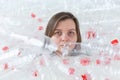 Dehydrated sick woman is lying in a pile of plastic bottles. Environmental pollution problem. Stop nature garbage