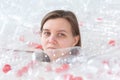 Dehydrated sick woman is lying in a pile of plastic bottles. Environmental pollution problem. Stop nature garbage