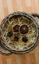 Dehydrated Slices Of Grapefruit And Pine Cones On A Shavings Nest In A Homemade Wicker Pot