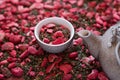 dehydrated strawberry-dried tea with mint and strawberries near tea pot. dry herbal tea with peppermint, strawberry Royalty Free Stock Photo