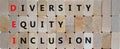 DEI, Diversity, equity, inclusion symbol. Wooden blocks with words DEI, diversity, equity, inclusion on beautiful wooden