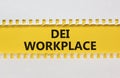 DEI diversity equity inclusion workplace symbol. Yellow paper with words DEI workplace on beautiful white background. Business DEI