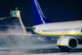 Deicing passenger airplane during heavy snow