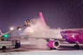 Deicing passenger airplane during heavy snow