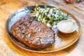 Deicious beef steak perfectly grilled over fire with side dishes served