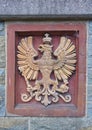 Deisfeld, Germany - August 2nd, 2018 - Heraldic relief in beige on red background depicting an imperial eagle wearing a crown and Royalty Free Stock Photo