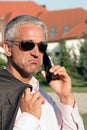 Dejected businessman using cell phone Royalty Free Stock Photo