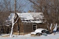 Delapidated car and cabin in winter