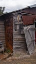 Delapidated shed rusty sheets metal wood doors falling off Royalty Free Stock Photo