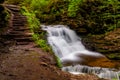 Delaware Falls and stairs along the Falls Trail in Ganoga Glen, Ricketts Glen State Park Royalty Free Stock Photo