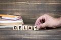 Delay. Wooden letters on the office desk Royalty Free Stock Photo