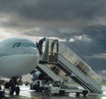 Delayed flight. Plane on stormy airport .