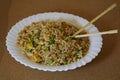 Delcious Special Fried rice in a white dish and Asian Chopsticks Royalty Free Stock Photo