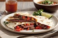 Beef quesadilla with tomato on a white plate