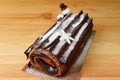 Delectable Buche de Noel or Chocolate Yule Log Cake for Christmas Sprinkle with Icing Sugar