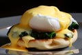 delectable close-up of vegetarian Eggs Benedict with sauteed spinach, tangy feta cheese, and perfectly poached eggs on a crispy