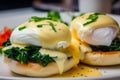 delectable close-up of vegetarian Eggs Benedict with sauteed spinach, tangy feta cheese, and perfectly poached eggs on a crispy