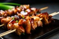 delectable close-up of yakitori skewers with tender chunks of chicken, marinated in a sweet and savory soy sauce