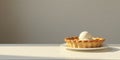 A delectable mini fruit tart with a scoop of creamy vanilla ice cream, bathed in soft sunlight on a pristine white surface. Royalty Free Stock Photo