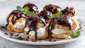 Delectable Profiteroles With Decadent Chocolate On A White Plate: Selective Focus Image In Soft Lighting. Luxurious And Appetizing Royalty Free Stock Photo