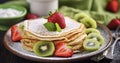 A Delectable Serving of Thin Crepes with Strawberry and Kiwi, Garnished with Raspberries and a Dusting of Powdered Sugar Royalty Free Stock Photo