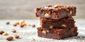 A delectable stack of three chocolate brownies, studded with nuts and dusted with powdered sugar, sits invitingly on a wood Royalty Free Stock Photo
