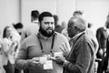 Delegates networking at a sales convention in large conference hall