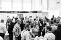 Delegates networking at a sales convention in large conference hall