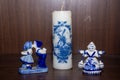 Delft Blue Figurine of girl carrying bells, kissing pair and candle Royalty Free Stock Photo