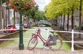 Delft city view in the Netherlands with water canal and vintage bicycle Royalty Free Stock Photo