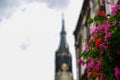 Delft, Netherlands, August 2019. The bell tower of the new church, in the Dutch Nieuwe Kerk. Close-up on the flowers that decorate Royalty Free Stock Photo