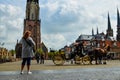 Delft,the Netherlands,August 2019.View on Markt square.The town hall,the new church and the characteristic Dutch houses overlook