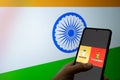 Man holding a mobile phone selecting covaxin and covishield in front of india flag as innoculation against the covid 19 Royalty Free Stock Photo