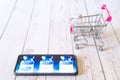 mobile phone showing vaccines choices covishield covaxin astrazeneca moderna pfizer with small shopping cart with Royalty Free Stock Photo